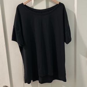 Large black Athleta top with seam across back